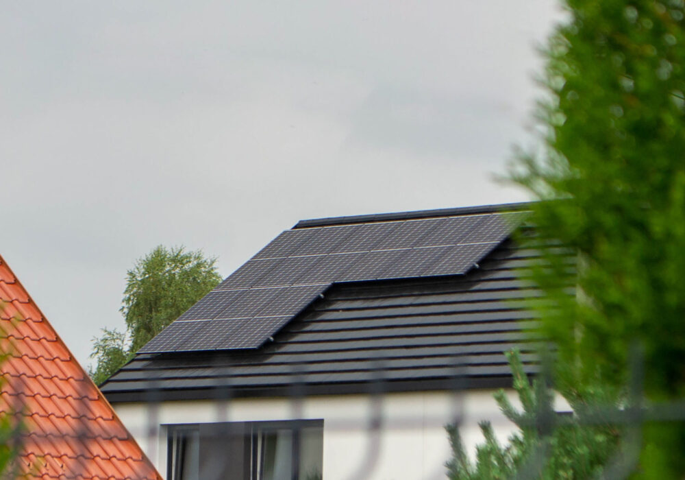House roof with photovoltaic modules. Historic farm house with modern solar panels on roof and wall High quality photo